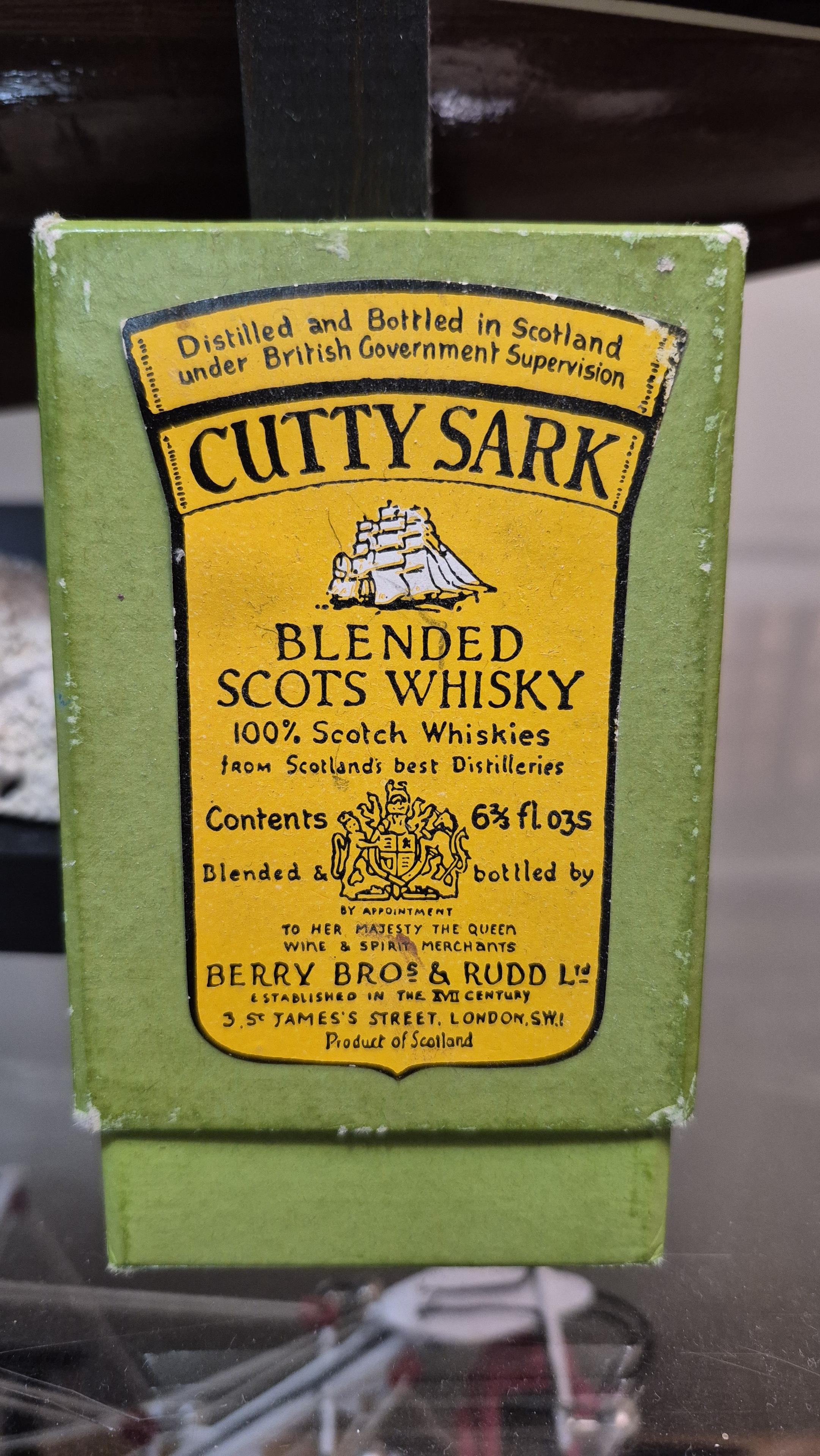An antique deck of cards with Cutty Sark branding.